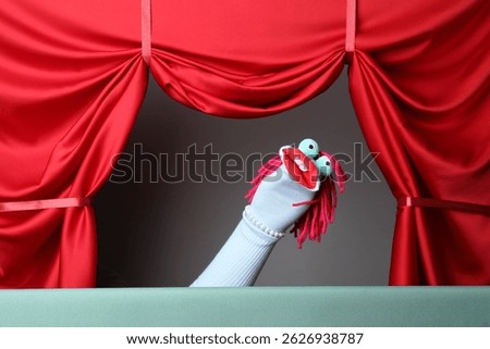 Creative puppet show on stage with red curtains