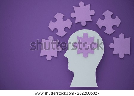 Creative representation of mental processes with puzzle pieces on a purple background. Symbolize cognitive functions and problem-solving skills. High quality photo