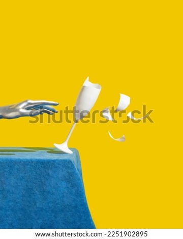 Creative retro futuristic composition with silver hand and broken white champagne glass falling of the blue plush table against bold yellow background. Cyberpunk style wild party concept. 