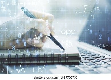 Creative scientific formula concept with hand writing in notebook on background with laptop. Multiexposure - Shutterstock ID 1999703732
