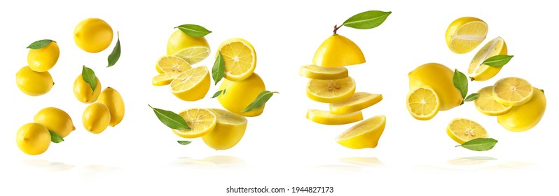 A creative set with Fresh raw whole and cut lemons with green leaves falling in the air isolated on white background. Food levitation or zero gravity conception. High resolution image