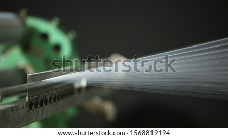 Creative shot of yarn thread running in the machine with spools in background 
Details of string reels in a factory
top view of A lot of yarn spools with textile factory, Threads running into the mach