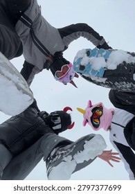 Creative Ski Boots Circle Perspective

Creative low-angle view of friends standing in a circle with ski boots touching together on snowy ground. Unique perspective symbolizing teamwork, friendship and winter adventure.