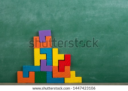 Creative solution for idea - business concept, jigsaw puzzle on the green blackboard background