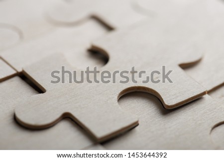 Creative solution for idea - business concept, jigsaw puzzle on the wooden background