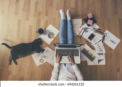 Creative space - Girl with her cat working - Shutterstock ID 694261132