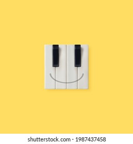 Creative Square Emoticon Made Of Piano Keys Isolated On Illuminating Yellow Background. Aesthetic, Abstract, Positive Emotion Music Concept. Happy Face Emoji. Minimal Flat Lay. Wallpaper Idea.