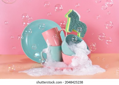 creative still life in bright colors with a sponge in the shape of a unicorn. The unicorn will say through the mountains of dirty dishes filled with foam for washing dishes surrounded by soap bubbles - Shutterstock ID 2048425238