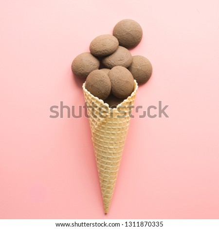 Similar – Ice cream cone with unpeeled peanuts on pink background