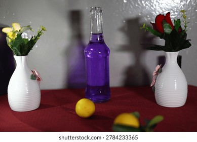 A creative still-life composition featuring white vases with flowers, eggs and fresh citrus fruits on a red surface with copy space.