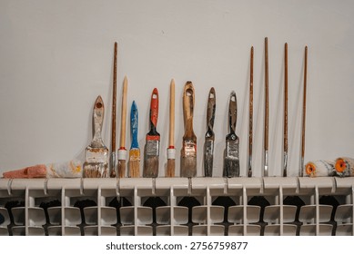 Creative Studio With Aged Brushes. Artistic Supplies Displayed Thoughtfully On Wellused Shelf