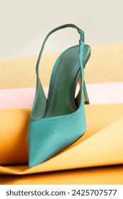 Creative studio shot of green satin slingbacks heels with the classy pointed toe, product photography	