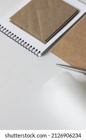 Creative Studio Space. Kraft Paper Rolls, Envelopes, Notebooks On Desk. Social Media, Freelance Work Concept.