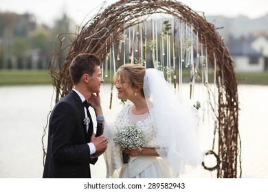creative stylish wedding ceremony elegant blonde bride and groom outdoors on the background the lake