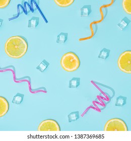 Creative Summer Background Composition With Lemon Slices, Straws And Ice Cubes. Minimal Top Down Lemonade Drink Concept.