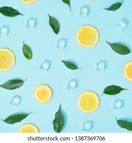 Creative Summer Background Composition With Lemon Slices, Leaves And Ice Cubes. Minimal Top Down Lemonade Drink Concept.