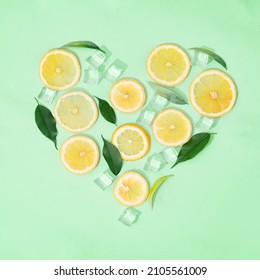 Creative Summer Composition With Lemon Slices, Ice Cubes. Minimal Top Down Lemonade Drink Concept. Heart Shape, Valentine Greeting
