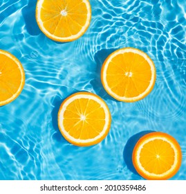 Creative summer composition made of sliced orange in transparent pool water. Refreshment concept. Healthy refreshing drink theme. Top view - Powered by Shutterstock