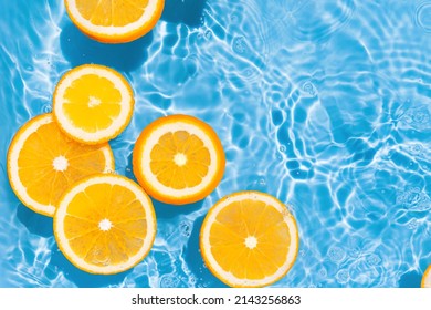 Creative summer composition made of sliced orange in transparent pool water. Refreshment concept. Healthy refreshing drink theme. Top view - Shutterstock ID 2143256863