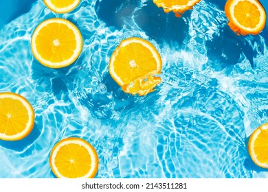 Creative summer composition made of sliced orange in transparent pool water. Refreshment concept. Healthy refreshing drink theme. Top view - Shutterstock ID 2143511281