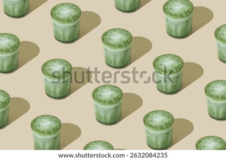Creative summer pattern made of iced matcha latte on beige background. Minimal healthy matcha latte concept. Trendy drink idea.