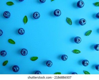 Creative Summer Round Frame Made Of Blueberries On Bright Blue Background. Original Blueberry Decoration. Minimal Summer Concept. Welcome Summer. Copy Space.