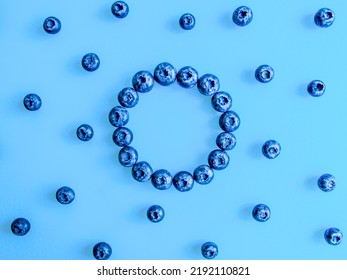 Creative Summer Round Frame Made Of Blueberries On Bright Blue Background. Original Blueberry Decoration. Minimal Summer Concept. Welcome Summer. Copy Space.