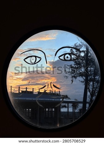 Creative sunset view through a round window with minimalist face illustration overlooking the ocean. Perfect for abstract art, travel, architecture, and coastal lifestyle concepts.