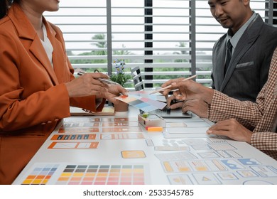 Creative Team Collaborating on UX UI Design Concepts with Color Swatches and Wireframes in Modern Office Setting - Powered by Shutterstock