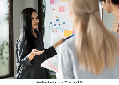 Creative Team Collaborating on UX UI Design Project with Wireframes and Color Swatches in Modern Office Setting - Powered by Shutterstock