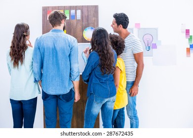 Creative team looking at color sample in office
