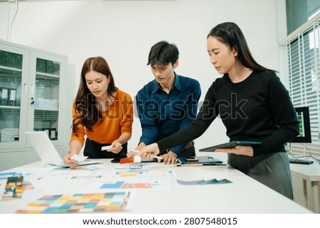Creative team planning UI UX mobile app interface with wireframes and analytics, collaborating on digital product design, business strategy, and innovative technology development.