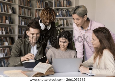 Creative teamwork in peer learning. Multiracial university students teens work together in classroom talk share knowledge brainstorm prepare for class project using notebook paper books written notes