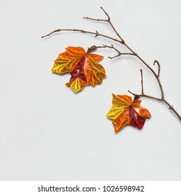 Creative thanksgiving day concept photo of a branch with leaves made of paper on white background.