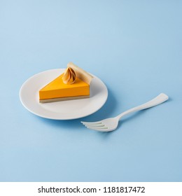 Creative Thanksgiving Day Concept Photo Of A Pumpkin Pie Made Of Paper On Blue Background.