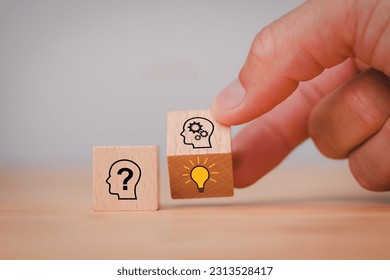 It's creative thinking idea and innovation concept with Hand flipping wooden block cube change from human question to smart thinking and solution problem.