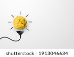 Creative thinking ideas and innovation concept. Paper scrap ball yellow colour with light bulb symbol on white background