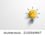 Creative thinking ideas and innovation concept. Paper scrap ball yellow colour with light bulb symbol on white background