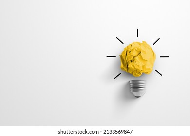 Creative thinking ideas and innovation concept. Paper scrap ball yellow colour with light bulb symbol on white background