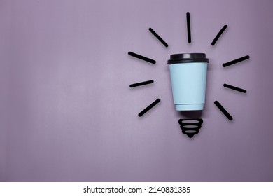 Creative Thinking Ideas And Innovation Concept. A Ball Of Takeaway Coffee Cup With A Light Bulb Symbol On A Purple Background. Time For Coffee.