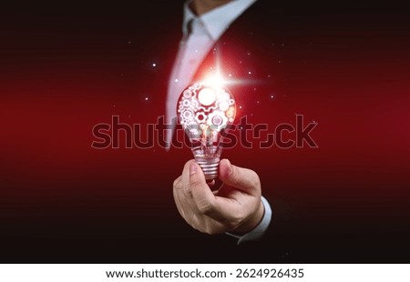 Creative thinking process concept. Businessman hold light bulb with gear icon. Meaning of excellent ideas, innovative design, and new inspiration in self-learning