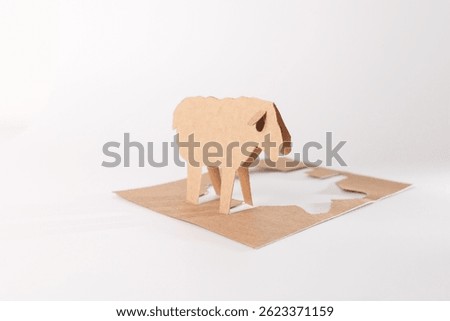 creative three dimensional sheep craft from cardboard. brown paper split by fold. cut-out of sheep's body. Creative craft project for 3D effect and DIY design ideas