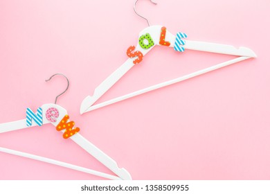 Creative top view flat lay white wooden hangers sale text pastel pink background copy space minimalism style. Template fashion feminine social media sale children store promo design shopping concept - Shutterstock ID 1358509955