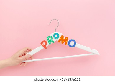 Creative top view flat lay white wooden hangers promo text pastel pink background copy space minimalism style. Template fashion feminine blog social media sale store promo design shopping concept