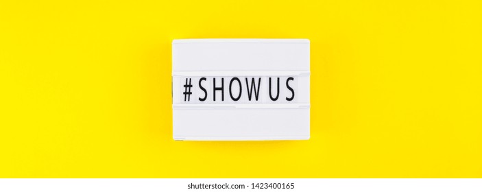 Creative Top View Flat Lay Of Lightbox With Hashtag Show Us Message Bold Yellow Background Minimal Style. 