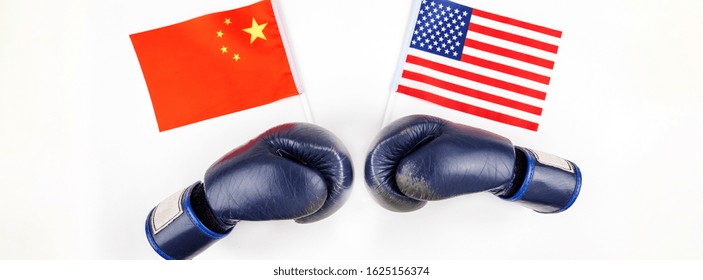 Creative top view flat lay of Two boxing gloves with China and USA flag and copy space on white background in minimal style. Concept of trade war between USA and China