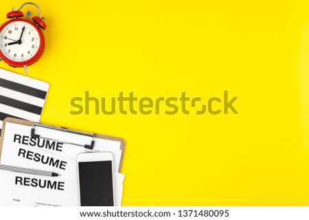 Creative top view flat lay of desk with resume documents copy space on bold yellow background in minimal style. Concept of new job, hiring recruitment process, new team members screening