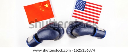Creative top view flat lay of Two boxing gloves with China and USA flag and copy space on white background in minimal style. Concept of trade war between USA and China