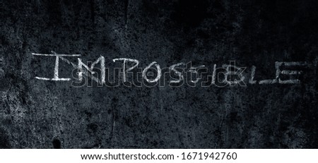 Creative and unique Possible written on a rough wall. Shot of impossible word written with a cross on Im making Possible. Think Different Concept.