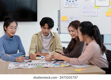 Creative UX Developer and UI Designer Team Brainstorming Session in Modern Office with Colorful Sticky Notes and Diagrams